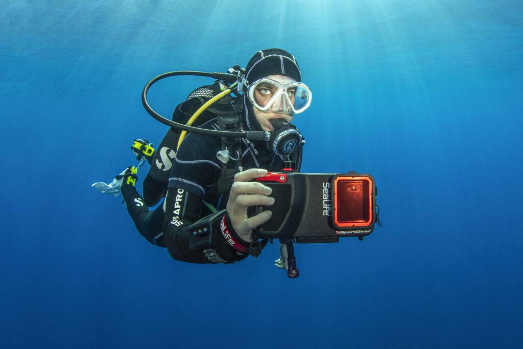 Diver using a SeaLife SportDiver underwater smartphone housing