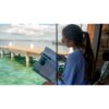 Student reading dive theory beside the water — official PADI Dive Theory course photograph
