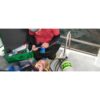 Student assisting a person using an emergency oxygen mask — official PADI Emergency Oxygen Provider course photograph