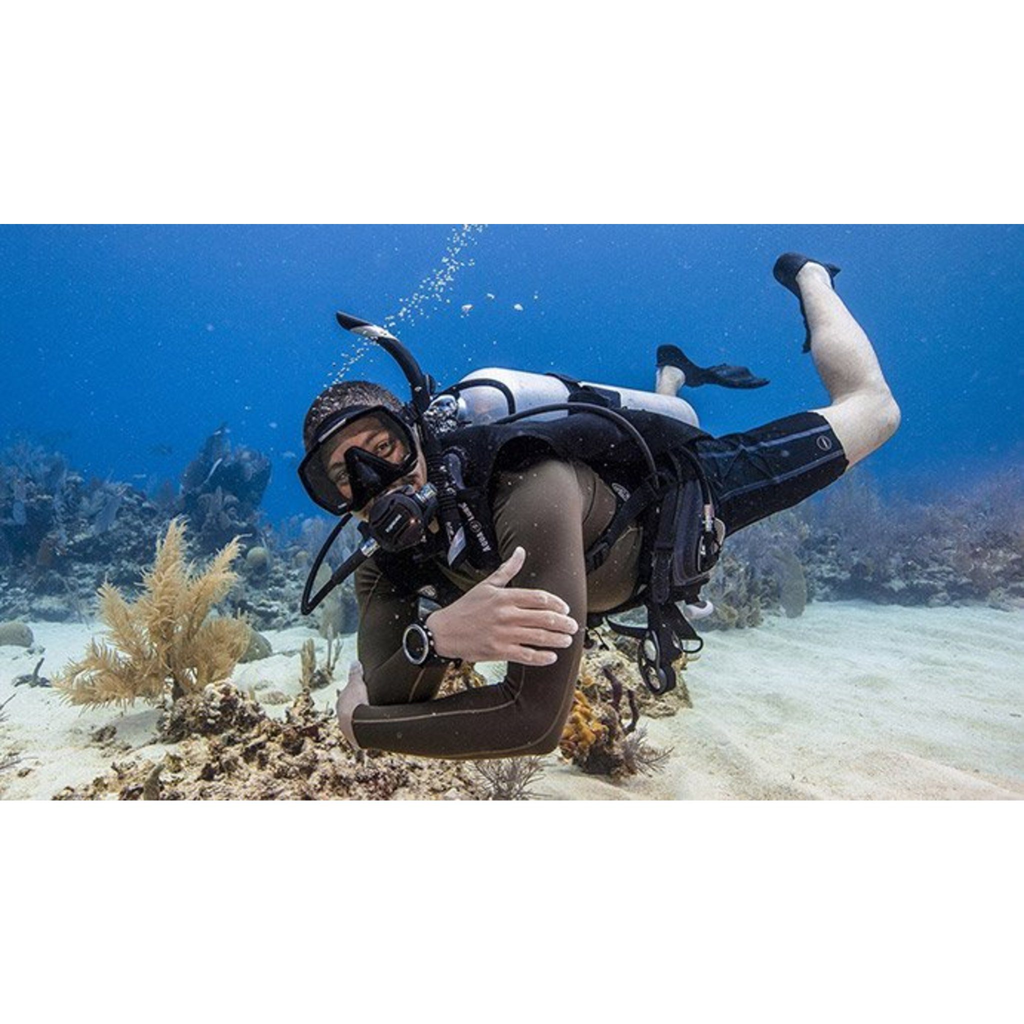Diver practising scuba skills above a sandy seabed — official PADI ReActivate Scuba Refresher Program course photograph